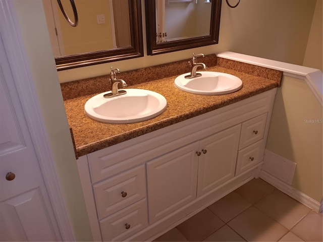 bathroom featuring double vanity, tile patterned floors, and a sink