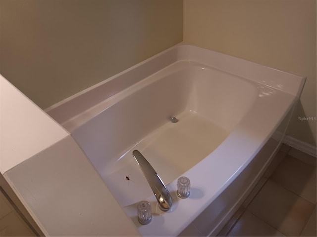 full bath with tile patterned floors and a tub