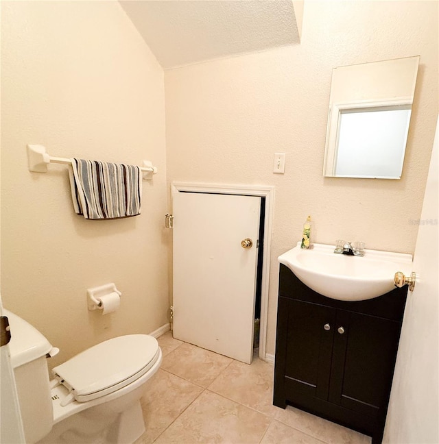 bathroom featuring vanity, tile patterned floors, toilet, and baseboards