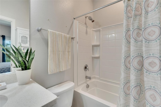 full bathroom with vanity, toilet, shower / tub combo with curtain, and a textured wall