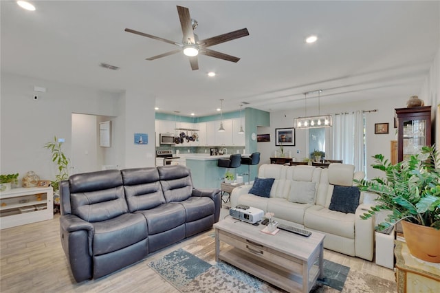 living area with visible vents, recessed lighting, light wood-style flooring, and a ceiling fan