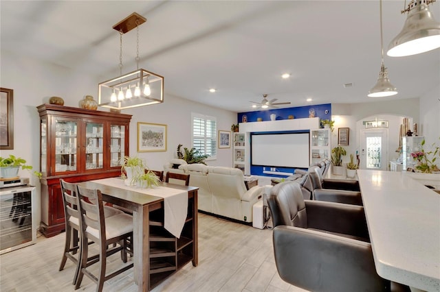 dining space with recessed lighting, arched walkways, ceiling fan, and light wood finished floors