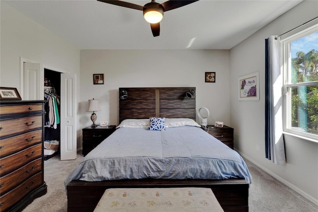 bedroom with a ceiling fan, carpet, baseboards, and a closet