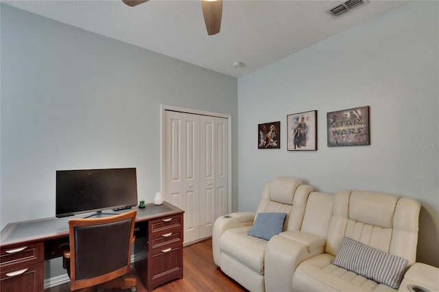 office space with wood finished floors, a ceiling fan, and visible vents