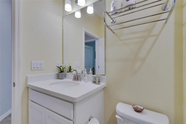 bathroom with toilet and vanity