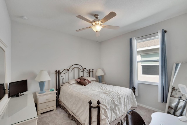 bedroom with baseboards, light colored carpet, and a ceiling fan