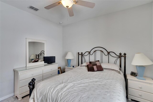 bedroom featuring a ceiling fan, visible vents, carpet floors, and baseboards