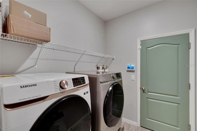 laundry room featuring washer and clothes dryer, laundry area, and baseboards