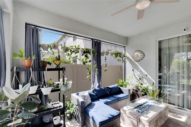 sunroom / solarium featuring ceiling fan