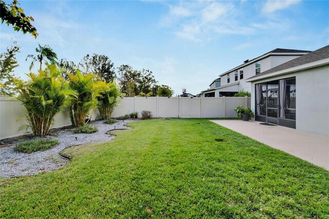 view of yard featuring a patio area and a fenced backyard