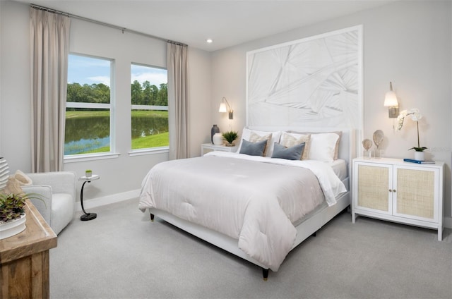 17420 Moonflower Dr Unit 101, Venice, FL 34293 - bedroom with carpet flooring, a water view, baseboards, and recessed lighting