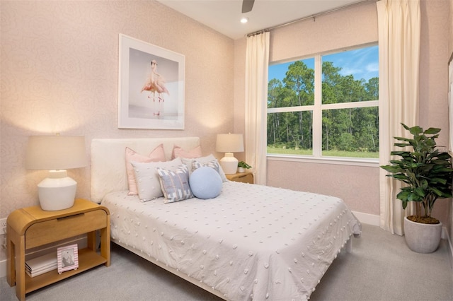 17420 Moonflower Dr Unit 101, Venice, FL 34293 - carpeted bedroom with a ceiling fan, wallpapered walls, and baseboards