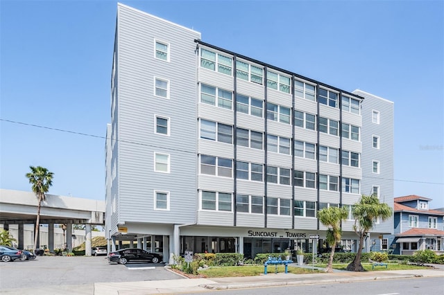 view of building exterior featuring uncovered parking