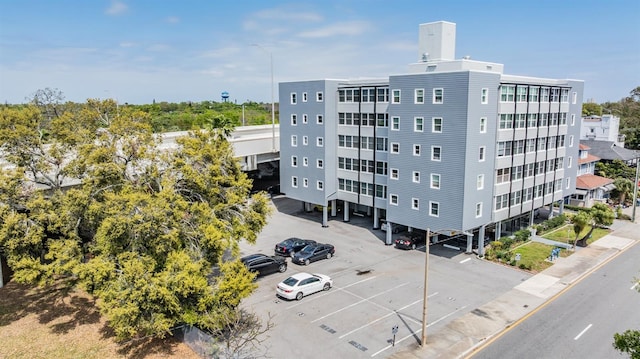 view of building exterior featuring uncovered parking