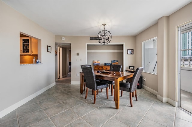 tiled dining room featuring visible vents, baseboards, and an inviting chandelier
