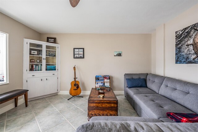 living room featuring light tile patterned flooring and baseboards