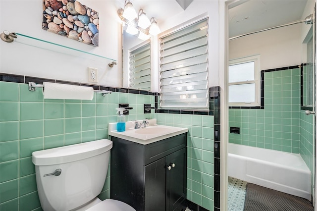 bathroom featuring tile patterned floors, toilet, tile walls, and vanity