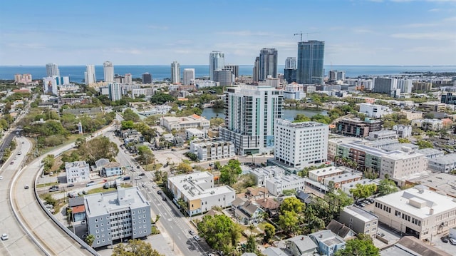 birds eye view of property featuring a view of city and a water view