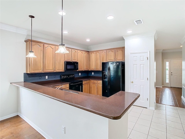 kitchen featuring dark countertops, tasteful backsplash, ornamental molding, a peninsula, and black appliances