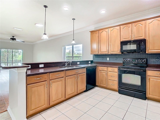 kitchen with black appliances, a peninsula, backsplash, and a sink