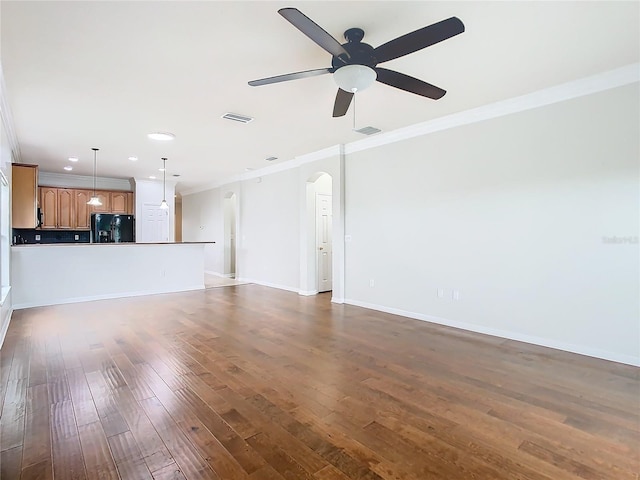 unfurnished living room with visible vents, arched walkways, dark wood-type flooring, and ornamental molding