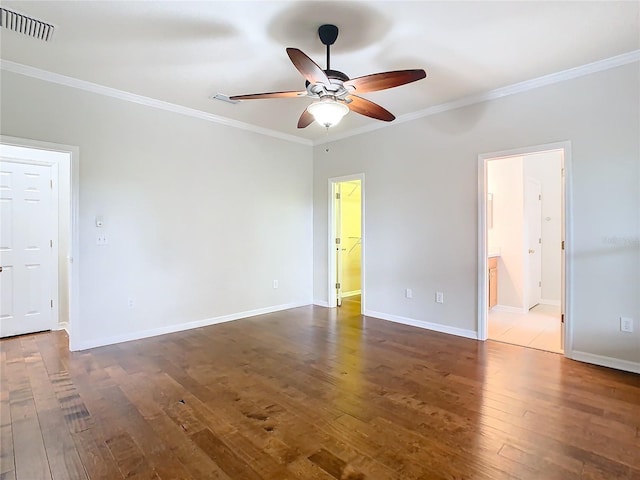 unfurnished bedroom with baseboards, dark wood finished floors, and crown molding