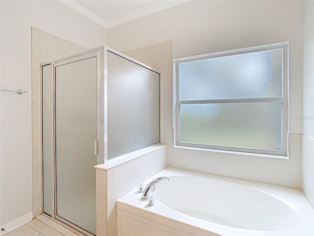 bathroom with tile patterned floors, a garden tub, a stall shower, and ornamental molding