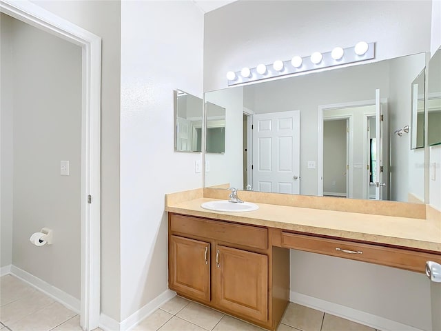 bathroom featuring baseboards, vanity, and tile patterned flooring