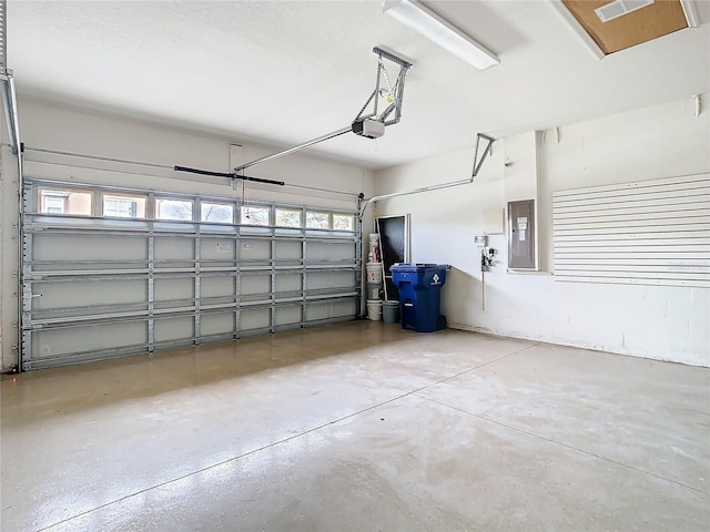 garage featuring electric panel and a garage door opener