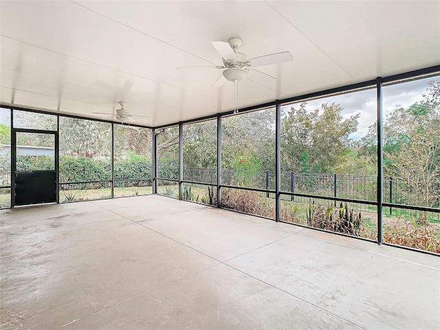 unfurnished sunroom featuring ceiling fan