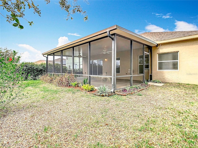 exterior space with a yard and a sunroom