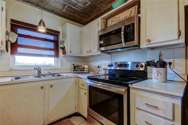 kitchen with appliances with stainless steel finishes, an ornate ceiling, and decorative backsplash