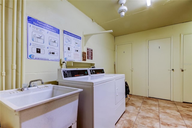 community laundry room with light tile patterned flooring, separate washer and dryer, and a sink