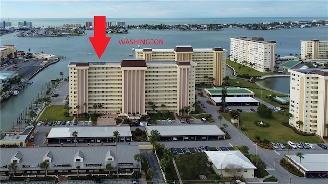 birds eye view of property with a view of city and a water view