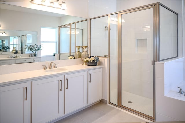 full bathroom featuring tile patterned floors, a shower stall, and vanity