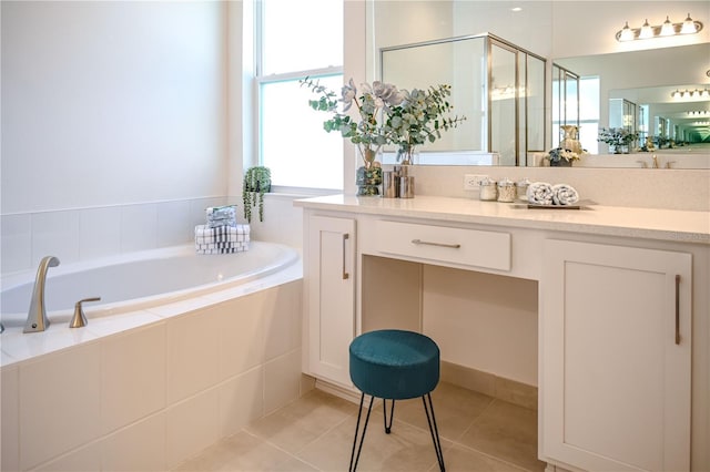 bathroom with vanity, a shower stall, a bath, and tile patterned floors