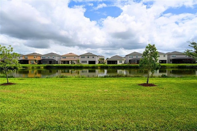 view of yard featuring a residential view and a water view