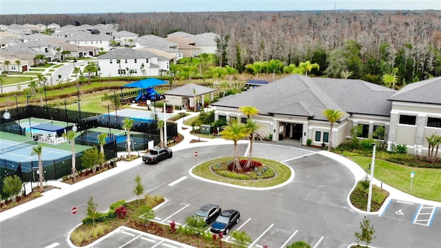 birds eye view of property with a residential view and a view of trees