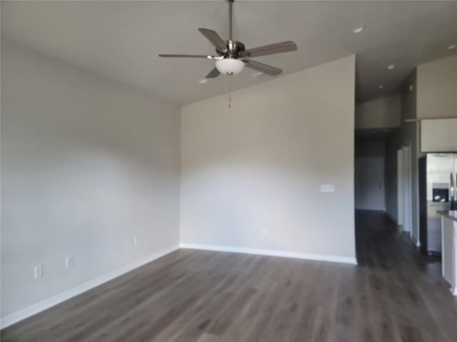 3312 Lila St, Tampa, FL 33610 - spare room with baseboards, lofted ceiling, a ceiling fan, and dark wood-style floors