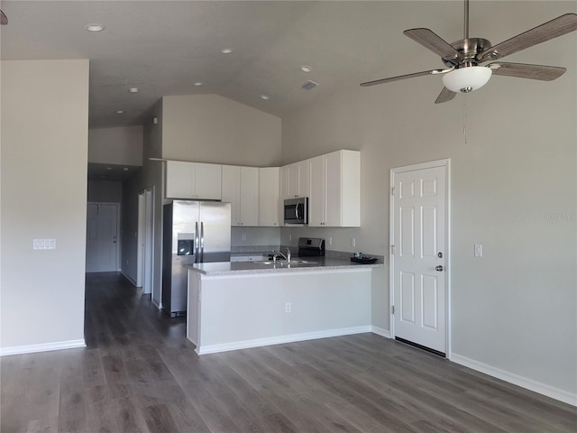 3312 Lila St, Tampa, FL 33610 - kitchen featuring baseboards, white cabinetry, a peninsula, high vaulted ceiling, and stainless steel appliances