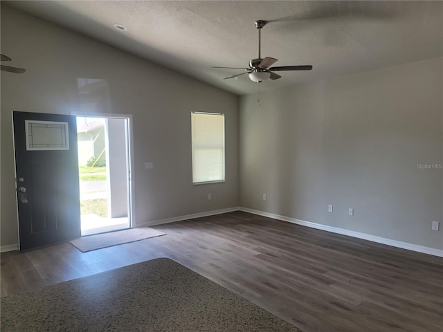 3312 Lila St, Tampa, FL 33610 - unfurnished room with lofted ceiling, a textured ceiling, dark wood-style flooring, a ceiling fan, and baseboards