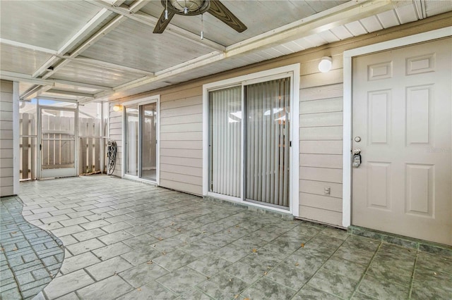 view of patio featuring ceiling fan and fence