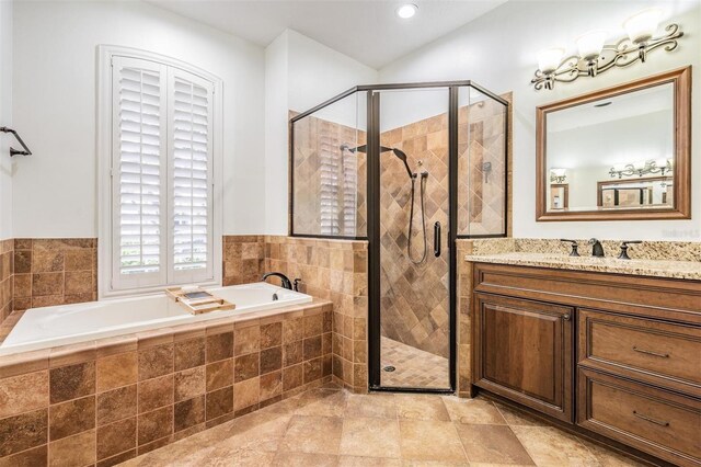 bathroom with vanity, a shower stall, and a bath