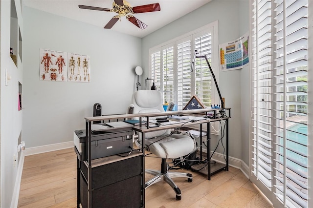 home office with ceiling fan, baseboards, and wood finished floors