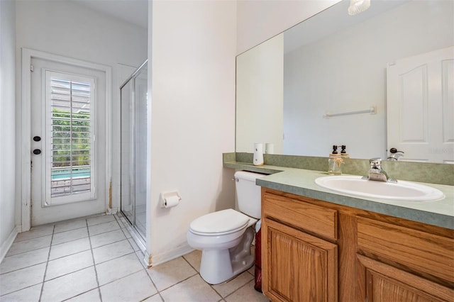 full bath with tile patterned flooring, baseboards, toilet, a stall shower, and vanity