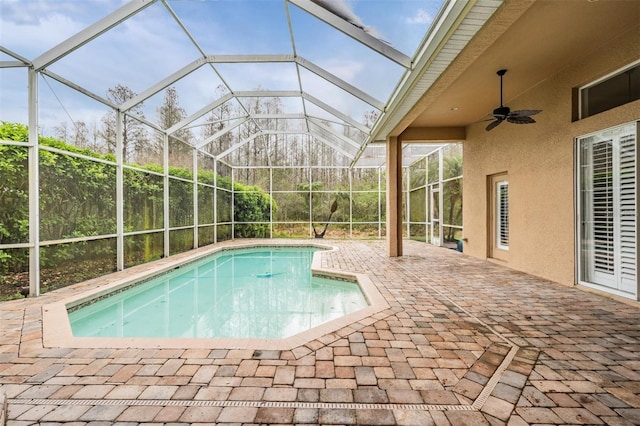 outdoor pool featuring a lanai, a patio, and ceiling fan