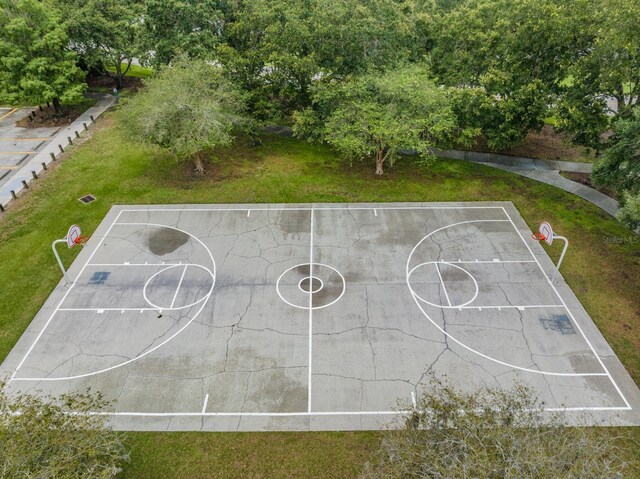 view of basketball court with a lawn and community basketball court