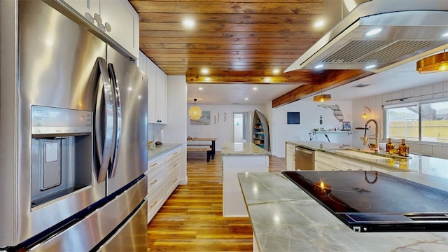 kitchen with a kitchen island, light wood-type flooring, appliances with stainless steel finishes, island exhaust hood, and a sink