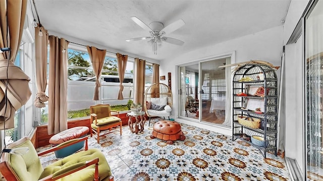 sunroom featuring a ceiling fan and a healthy amount of sunlight