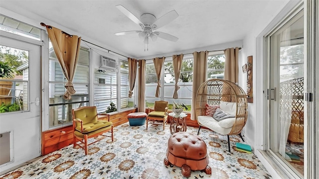 sunroom / solarium featuring an AC wall unit and a ceiling fan